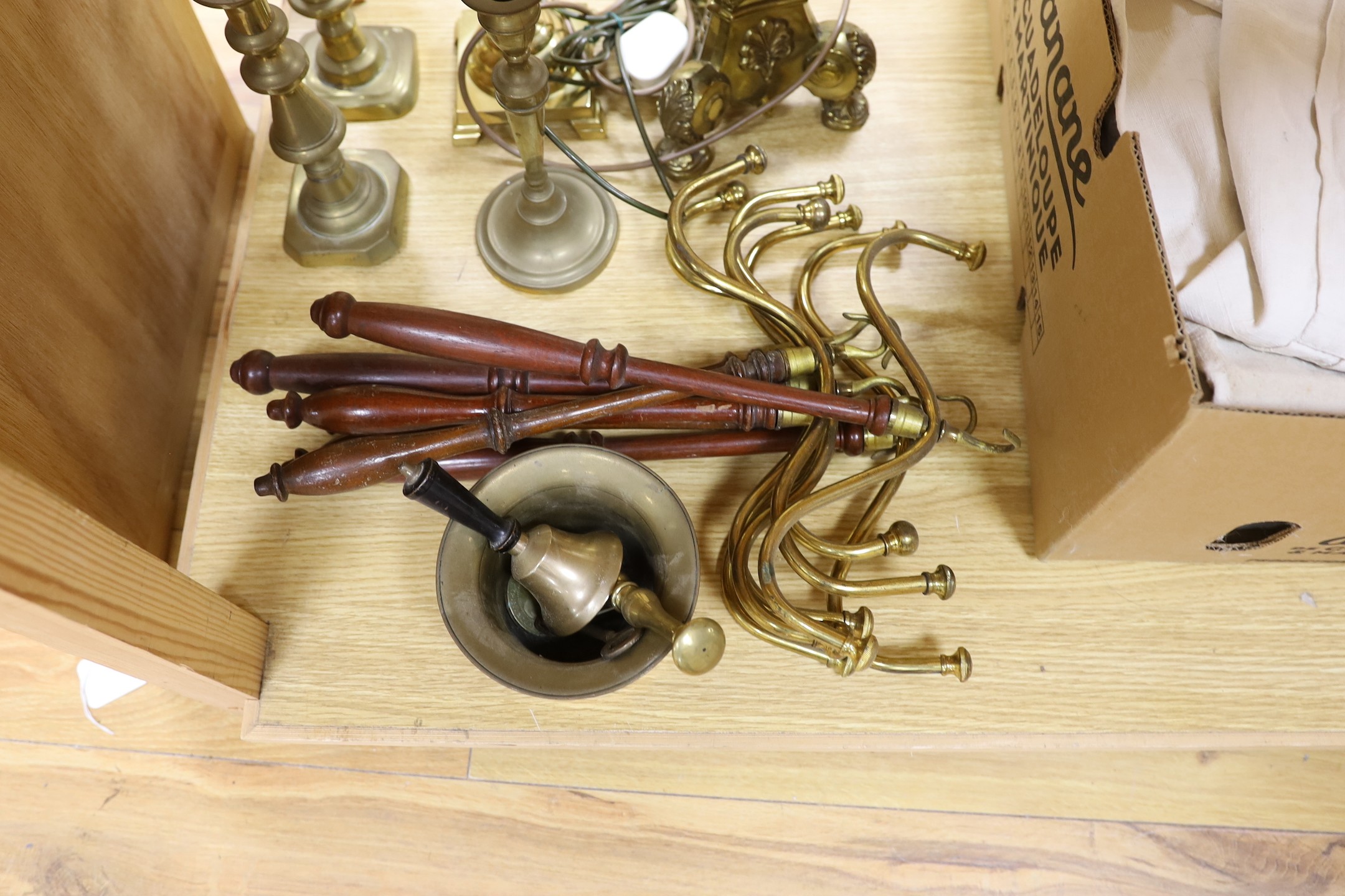 A group of mixed antique brass wares to include candlesticks, a mortar and pestle, etc